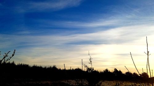 Silhouette landscape against sky during sunset