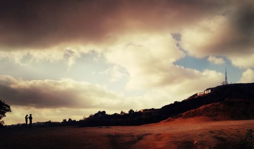 Scenic view of landscape against cloudy sky