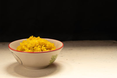 Close-up of orange juice in bowl on table
