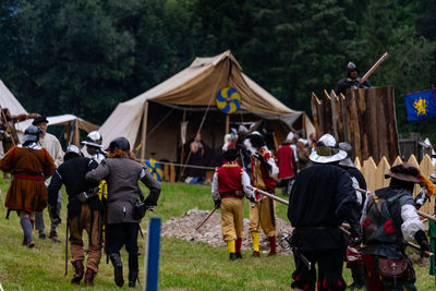 Rear view of people on field