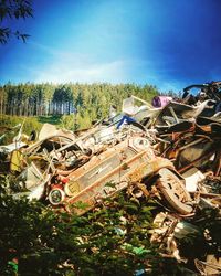 High angle view of abandoned cars on land against sky