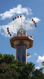 Low angle view of ferris wheel against blue sky