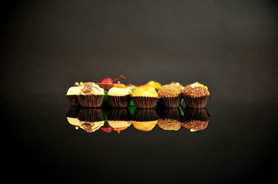 Close-up of cupcakes against black background