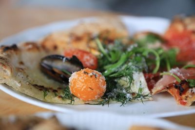 Close-up of pizza in plate on table