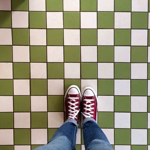 Low section of person standing on tiled floor