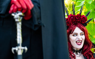 Close-up portrait of smiling young woman in costume