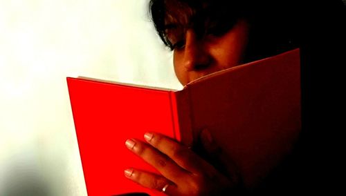 Close-up of young woman in red shirt