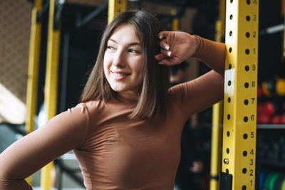 Portrait of young woman exercising in gym