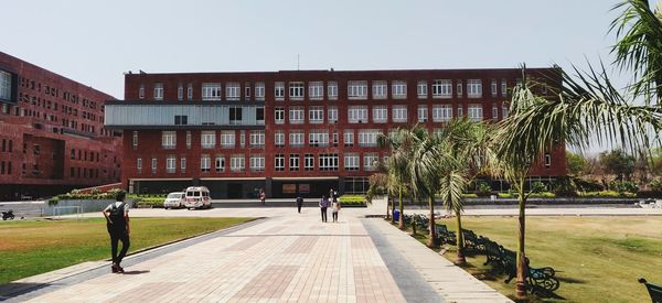 Street amidst buildings against clear sky