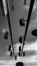 Low angle view of road signal against sky