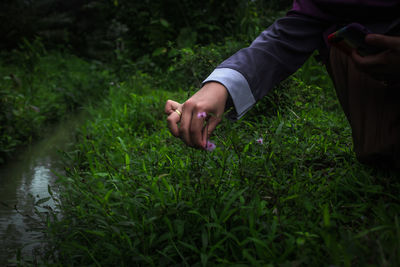 Midsection of person on grassy field