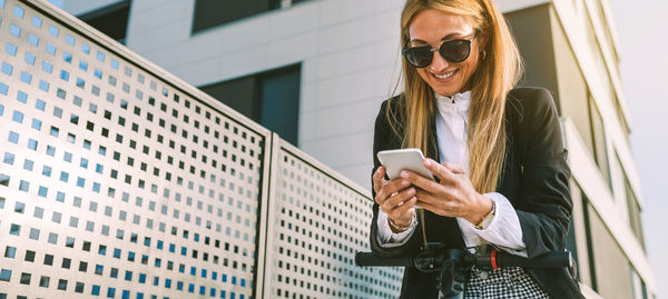 Midsection of woman using mobile phone