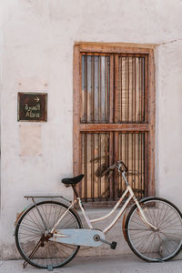 Bicycle parked by the wall in historic district with abra sign