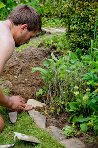 Side view of man gardening