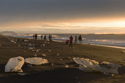 People enjoying at beach during winter