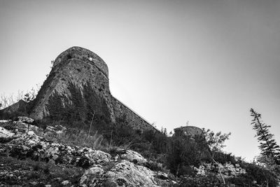 Low angle view of rock formation against clear sky