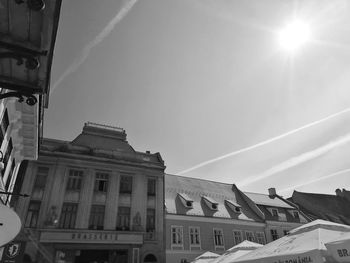 Low angle view of buildings against sky on sunny day