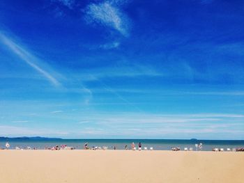 Scenic view of beach against blue sky