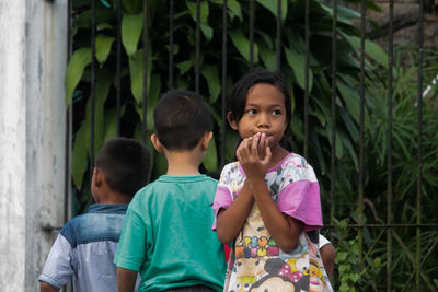 Children and girl looking at camera