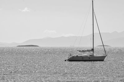 Boat sailing on sea against sky