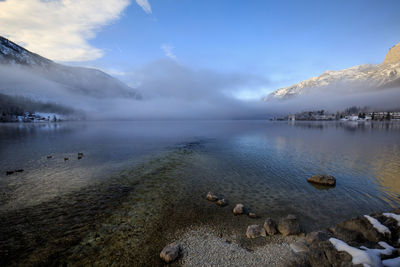 Scenic view of lake against sky during winter