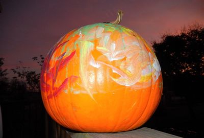 Close-up of pumpkin against trees during halloween