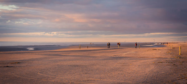 Scenic view of beach against sky during sunset