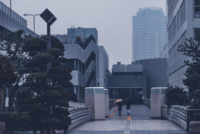 Rear view of modern buildings in city against sky