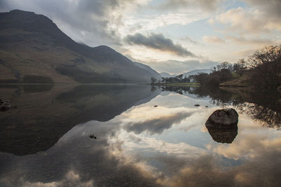 Scenic view of lake and mountains against sky