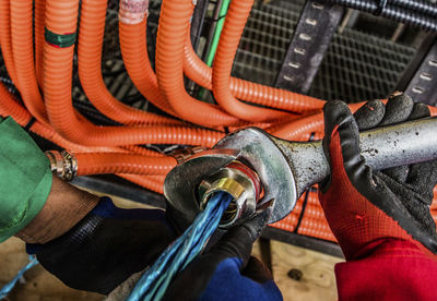 Close-up of person working on metal