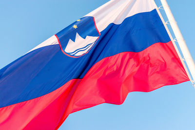 Large slovenia flag waving with blue sky