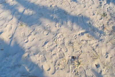 High angle view of footprints on sand at beach