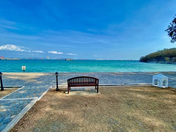 Lifeguard hut on beach against blue sky