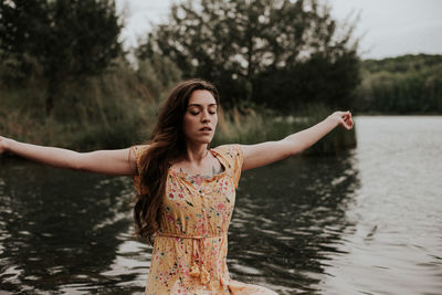 Portrait of young woman in lake