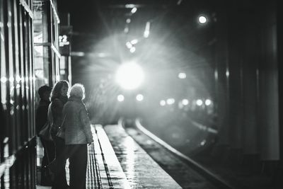 Man and woman in illuminated bus at night