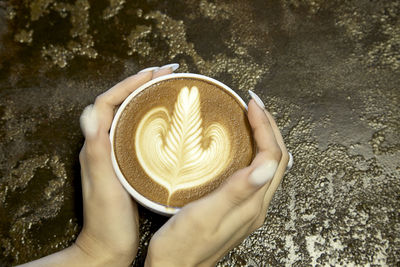 Midsection of woman holding coffee cup