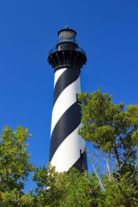 Low angle view of lighthouse against clear blue sky