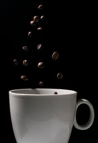 Close-up of coffee cup against black background