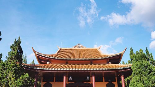 Low angle view of shrine against blue sky