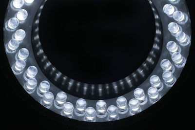 Close-up of illuminated white led lights against black background