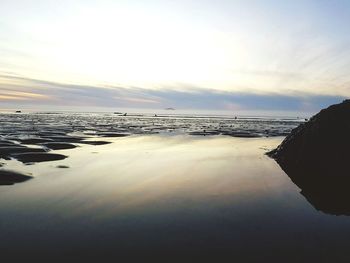 Scenic view of beach against sky during sunset