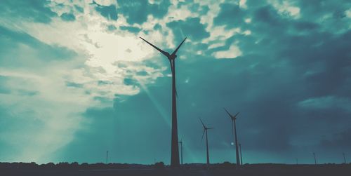 Low angle view of windmill against sky