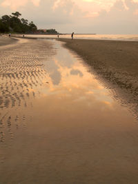 Scenic view of beach against sky during sunset