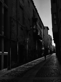 Empty alley amidst buildings in city