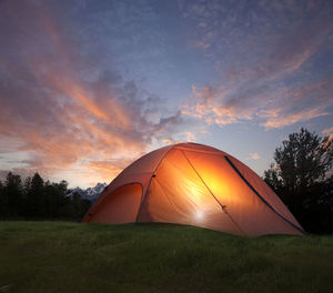 Tent against sky during sunset