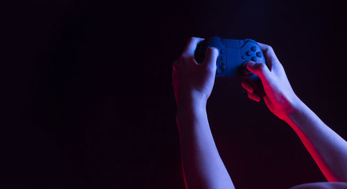 Close-up of human hand against black background