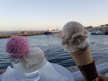 Close-up of ice cream cone against sky