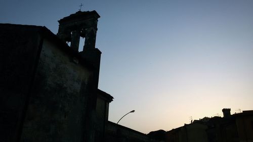 Low angle view of silhouette buildings against sky at dusk