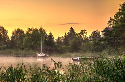 Scenic view of lake against sky during sunset