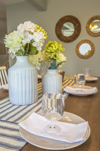 Close-up of white roses in vase on table